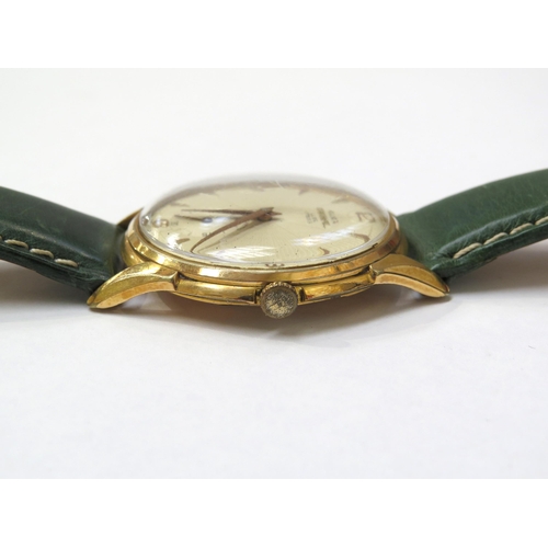 8155 - An Olma Divinal Luxe gentleman's wristwatch on a green leather strap, the textured dial with gilt Ar... 