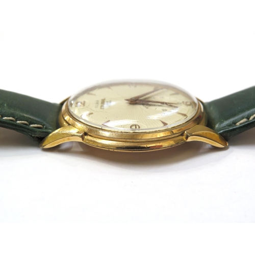 8155 - An Olma Divinal Luxe gentleman's wristwatch on a green leather strap, the textured dial with gilt Ar... 