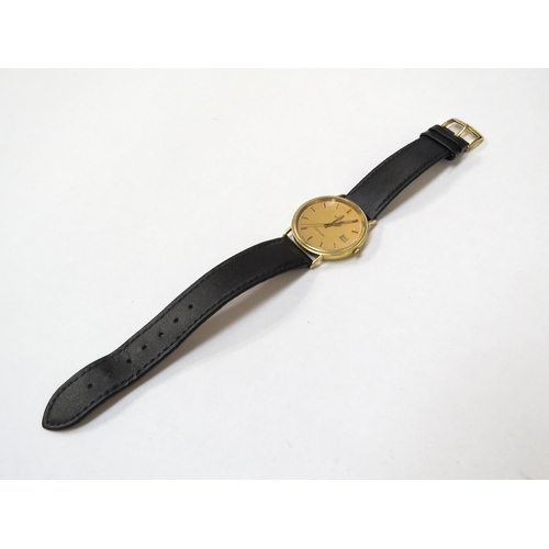 8156 - OMEGA: An 18ct gold cased Omega Seamaster gentleman's wristwatch on leather strap, the golden dial w... 