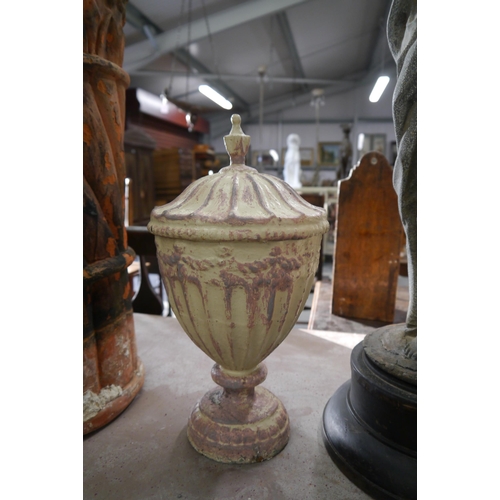 2024 - A small pair of Georgian style cast iron urns 37cm tall