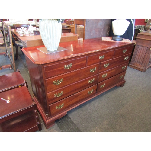 1035 - A large modern chest of nine drawers with brass handles, 87cm tall x 162cm wide x 49cm deep