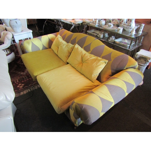 1164 - A modern two seater sofa upholstered with green and grey leaf design