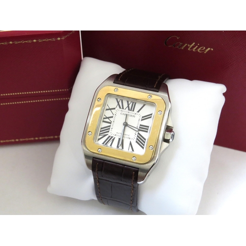 8190 - CARTIER: A gentleman's Cartier Santos 100 XL gold and stainless steel automatic wristwatch on leathe... 