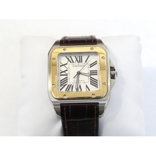 8190 - CARTIER: A gentleman's Cartier Santos 100 XL gold and stainless steel automatic wristwatch on leathe... 