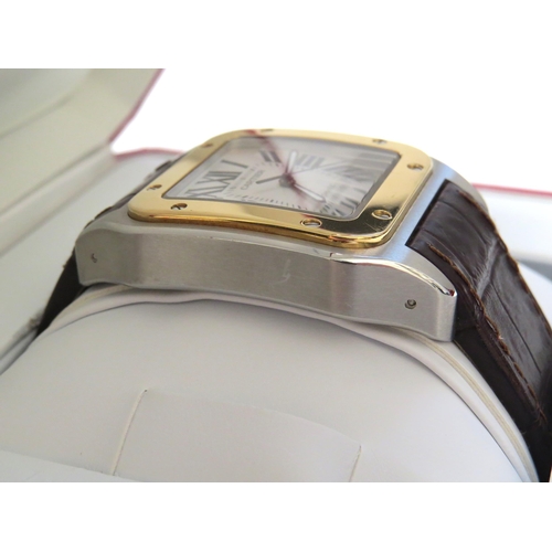 8190 - CARTIER: A gentleman's Cartier Santos 100 XL gold and stainless steel automatic wristwatch on leathe... 