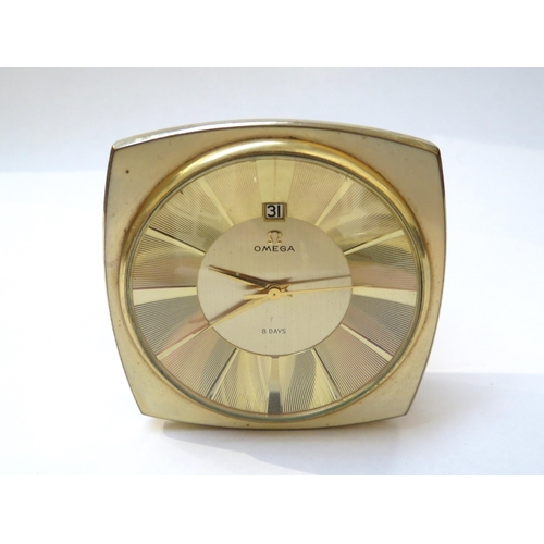 8116 - OMEGA: A circa 1960s Omega 8 days desk clock with date aperture, with Omega box