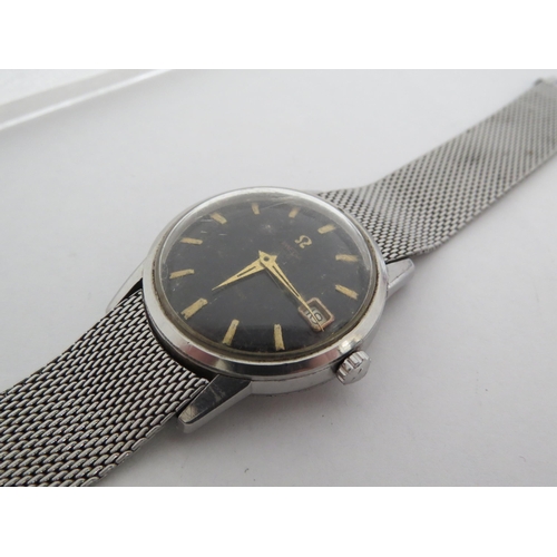 8175 - OMEGA: An Omega Seamaster automatic wristwatch circa 1961 with black dial, gold baton markers and ca... 