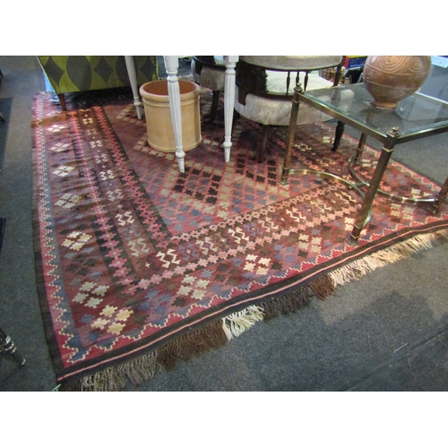 1565 - A dark geometric design wool kilim rug with tasselled ends, 3m x 2m