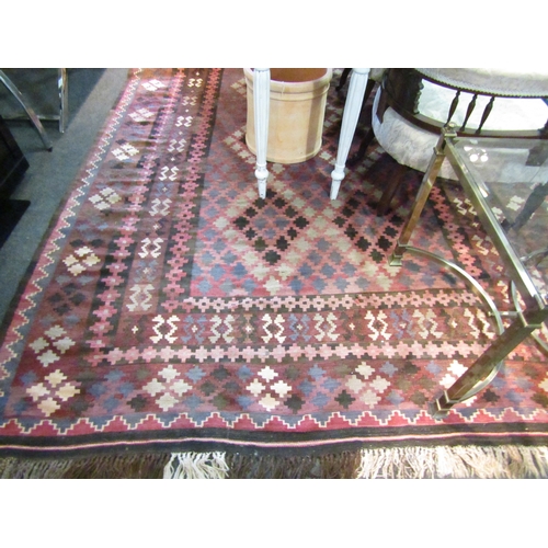 1565 - A dark geometric design wool kilim rug with tasselled ends, 3m x 2m