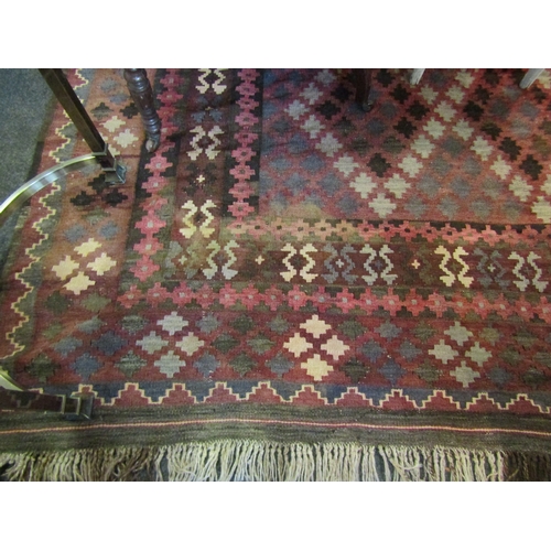 1565 - A dark geometric design wool kilim rug with tasselled ends, 3m x 2m