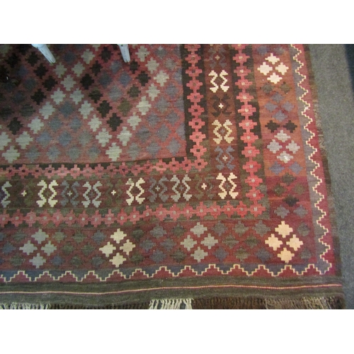 1565 - A dark geometric design wool kilim rug with tasselled ends, 3m x 2m