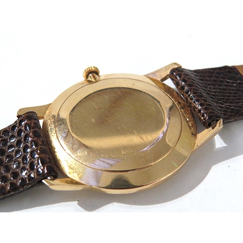 8141 - LONGINES: A Longines 18ct gold cased wristwatch on a Hirsch lizard leather strap, the thin gold case... 