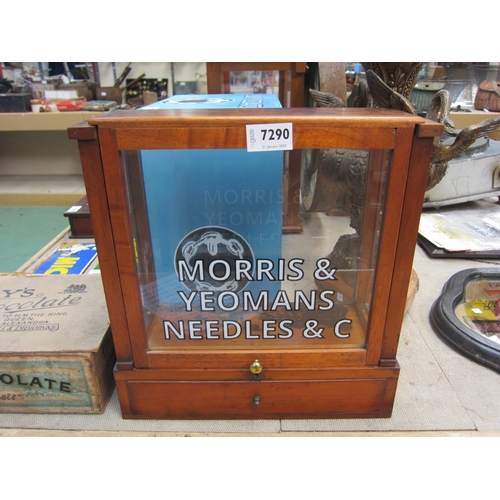 7290 - A glass display cabinet with later painted 'Morris Needles' lettering to front