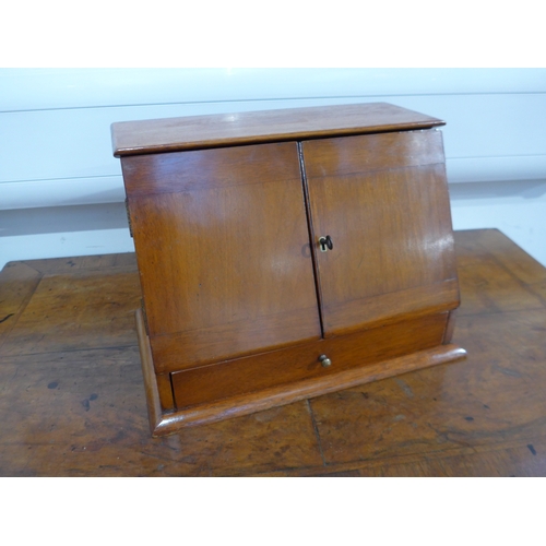 4041 - A 19th Century mahogany table-top apothecary cabinet, the two doors with key having a rising top and... 