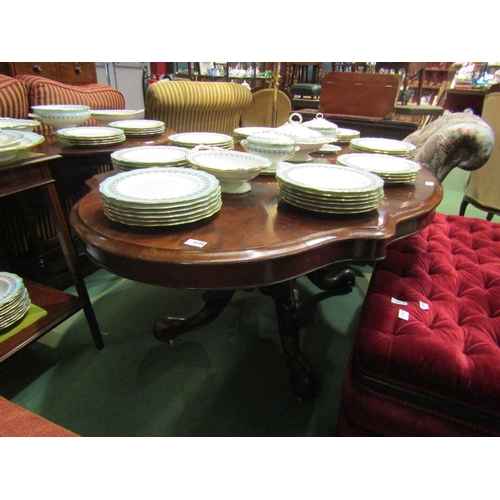 4157 - Circa 1850 a walnut tilt-top table, the serpentine sided top over a melon fluted and turned column o... 