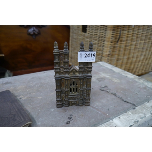 4374 - A small cast iron Cathedral form money bank, 16cm tall