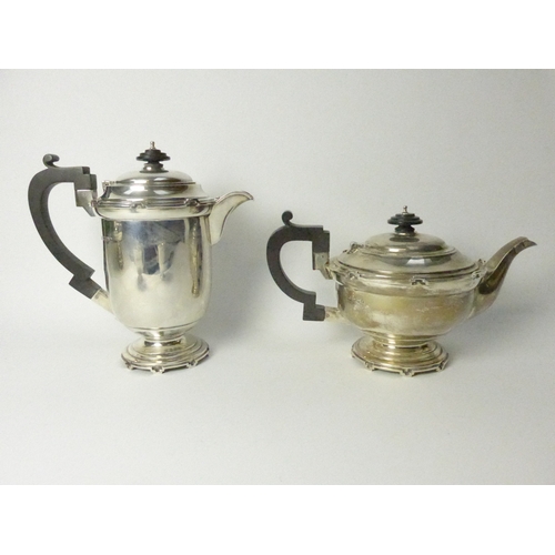 8001 - A Walker & Hall silver five piece castellated silver tea set, four pieces Sheffield 1934 and comport... 