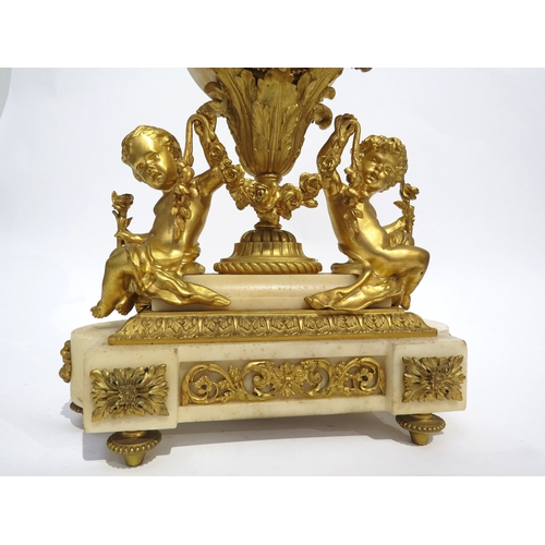 8055 - A 19th Century French ormolu/gilt metal and marble mantel clock, the floral decorated clock drum hel... 