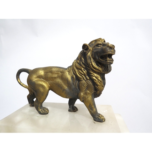 8034 - A continental white marble and gilt metal mantel clock surmounted by a cast metal lion all under a l... 