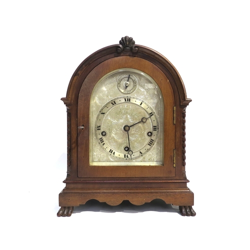 8066 - An English oak cased bracket clock, with ornately engraved silvered dial having Roman numeral chapte... 