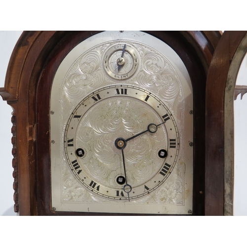 8066 - An English oak cased bracket clock, with ornately engraved silvered dial having Roman numeral chapte... 