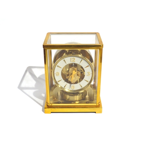 8083 - A Jaeger-LeCoultre brass cased Atmos mantel clock, the white chapter ring with Arabic numerals and a... 