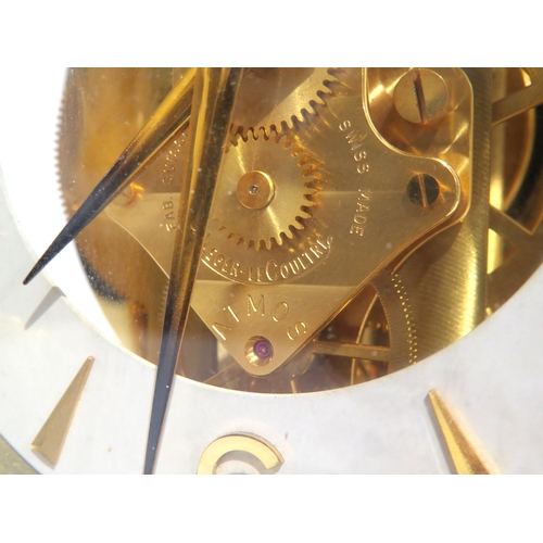 8083 - A Jaeger-LeCoultre brass cased Atmos mantel clock, the white chapter ring with Arabic numerals and a... 