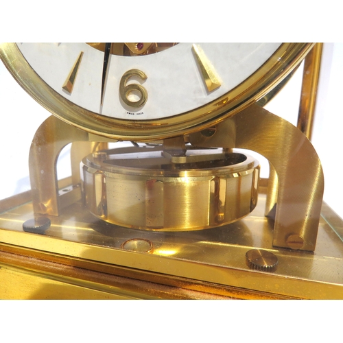 8083 - A Jaeger-LeCoultre brass cased Atmos mantel clock, the white chapter ring with Arabic numerals and a... 