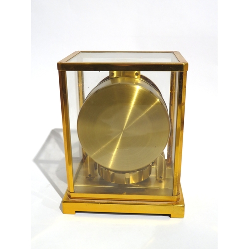 8083 - A Jaeger-LeCoultre brass cased Atmos mantel clock, the white chapter ring with Arabic numerals and a... 