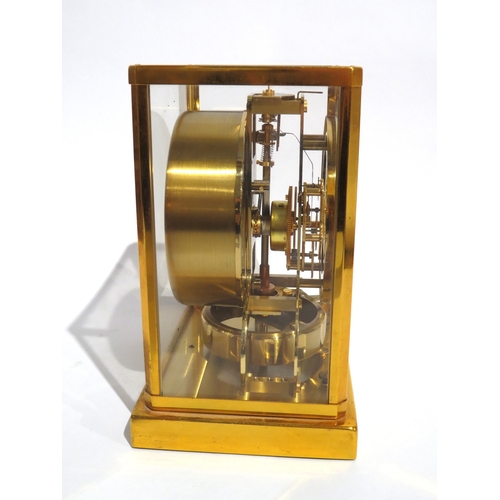 8083 - A Jaeger-LeCoultre brass cased Atmos mantel clock, the white chapter ring with Arabic numerals and a... 