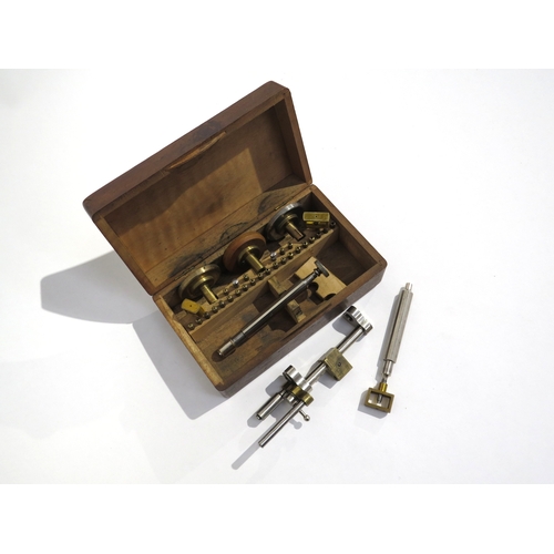 8202 - A cased screw-head polishing tool set with box vices, brass collets etc