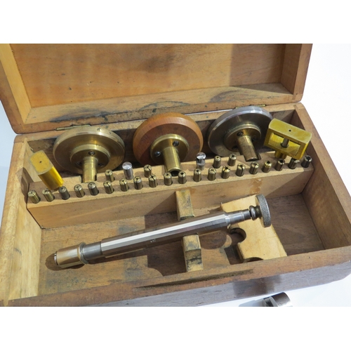 8202 - A cased screw-head polishing tool set with box vices, brass collets etc