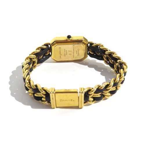 8185 - CHANEL: A circa 1987 Chanel Premiere lady's bracelet wristwatch, the strap with a black leather inla... 