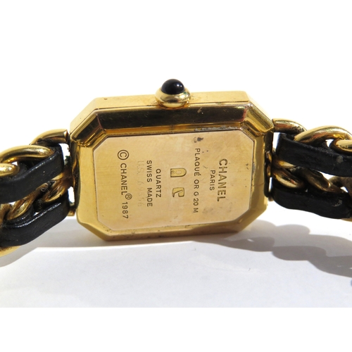 8185 - CHANEL: A circa 1987 Chanel Premiere lady's bracelet wristwatch, the strap with a black leather inla... 