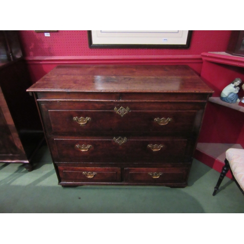 4033 - An 18th Century provincial oak chest, the hinged lid over two faux drawers and two short base drawer... 