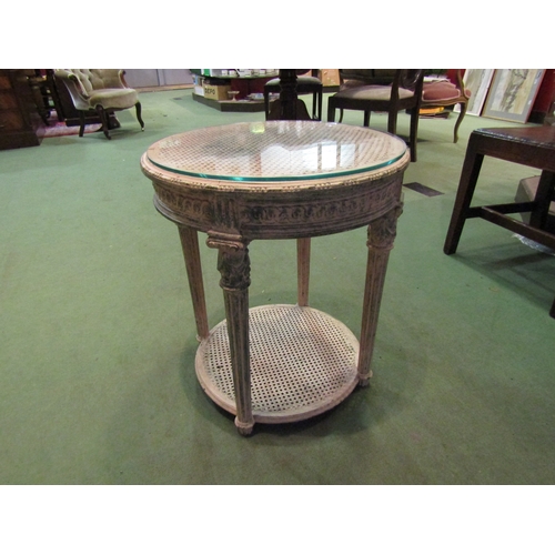 4008 - A French circular two-tier occasional table with cane top and glass protector, 56cm tall x 50cm diam... 