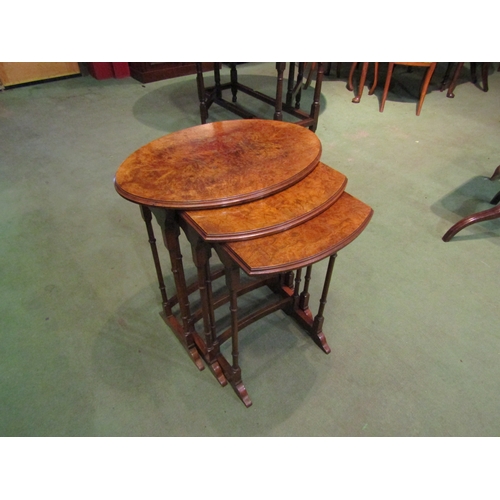 4011 - An Edwardian nest of three graduating burr walnut top occasional tables on ring turned legs and sled... 