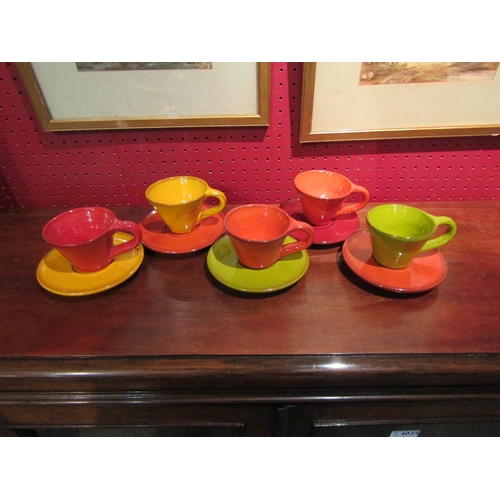 4022 - A collection of harlequin pottery cups and saucers