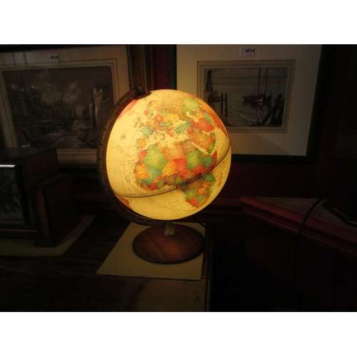 4032 - A desk top light-up globe with mahogany stand