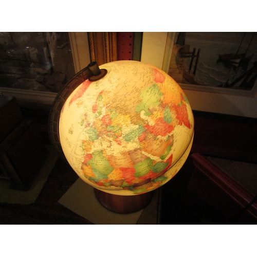 4032 - A desk top light-up globe with mahogany stand