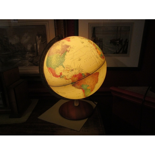 4032 - A desk top light-up globe with mahogany stand