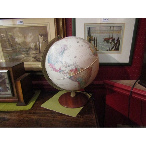 4032 - A desk top light-up globe with mahogany stand