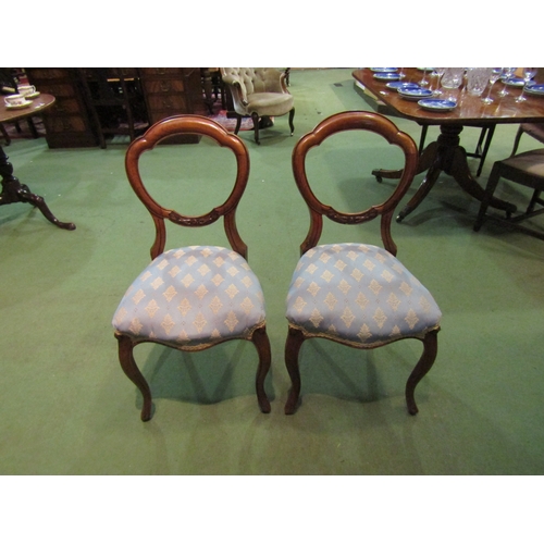 4060 - A circa 1860 pair of walnut balloon back chairs with carved decoration on French cabriole fore legs