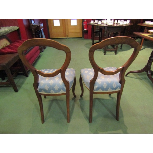 4060 - A circa 1860 pair of walnut balloon back chairs with carved decoration on French cabriole fore legs