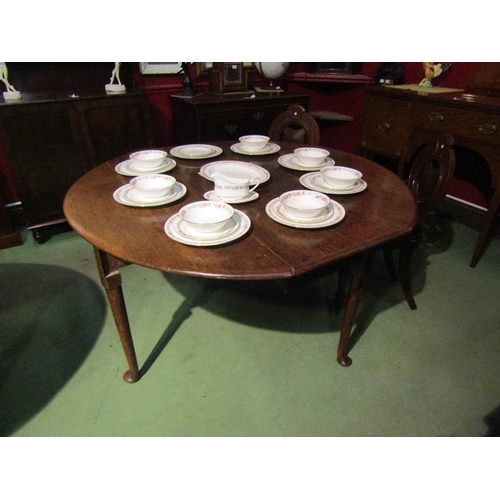 4061 - An 18th Century oak drop-leaf dining table on pad feet