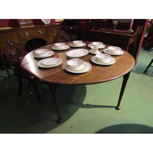 4061 - An 18th Century oak drop-leaf dining table on pad feet