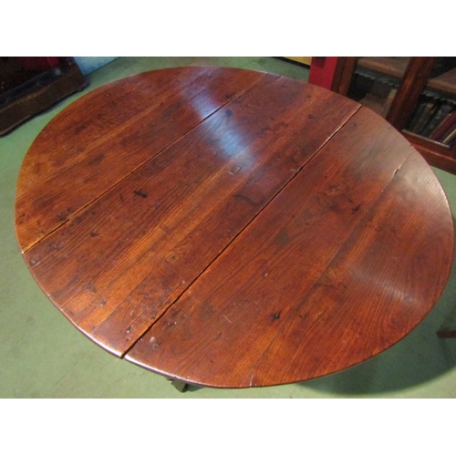 4063 - A Circa 1800 oval top pegged oak gateleg table the rising leaves over a single cutlery drawer on tur... 