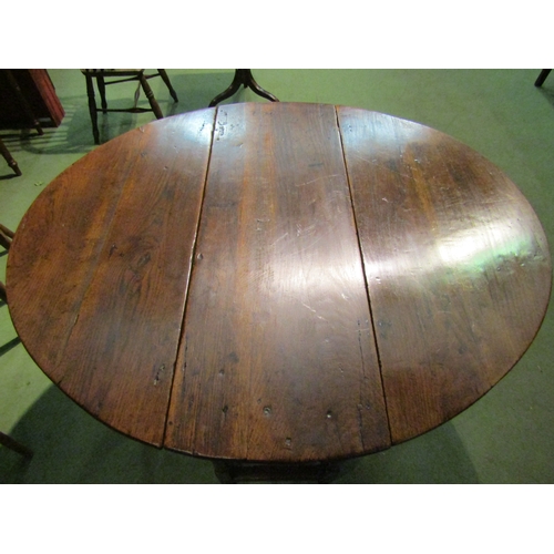 4063 - A Circa 1800 oval top pegged oak gateleg table the rising leaves over a single cutlery drawer on tur... 