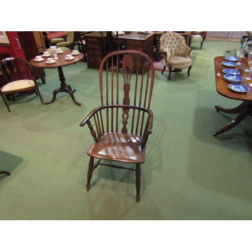 4065 - An elm seated hoop-back Windsor elbow chair, pierced splat back