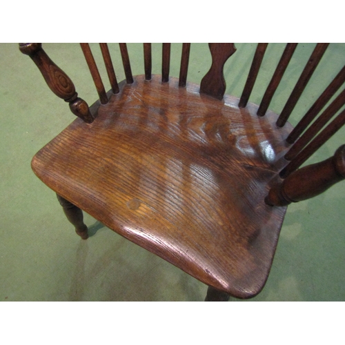 4065 - An elm seated hoop-back Windsor elbow chair, pierced splat back